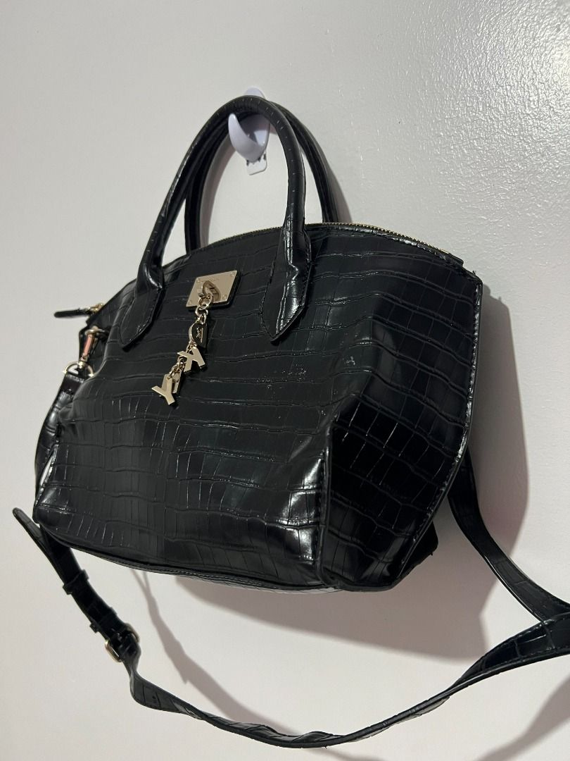 DKNY Elissa Croc-Embossed Leather Satchel (Black) (Category: Shoulder Bags) located in Davao. Submitted by jpnusapasabuyfindsdvo (Listing ID 1463896227, Image 3). Description: - NEVER USED BAG WITH A TAG, BOUGHT FROM USA - Stylish black satchel handbag - Features a sophisticated croc-embossed texture - Comes with a comfortable top handle - Includes a detachable shoulder strap for versatile wear - Secure zipper closure - Adorned with a cute, eye-c