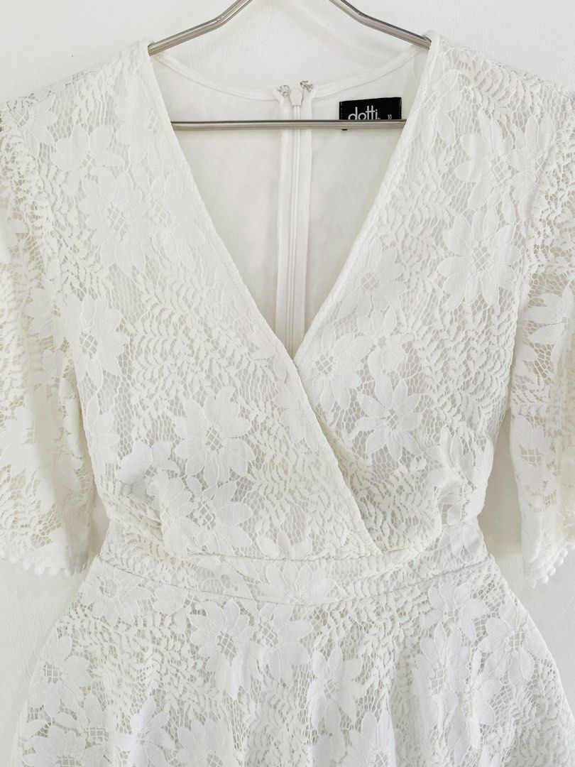 Dotti White Lace Wrap Romper (Category: Rompers) located in Vigan. Submitted by yourcloset1001 (Listing ID 1463912611, Image 2). Description: - Dotti white lace romper - Size 10 - Wrap front design - Flutter sleeves - Tiered ruffled hem - Tie detail at the back - Ideal for events or a night out.