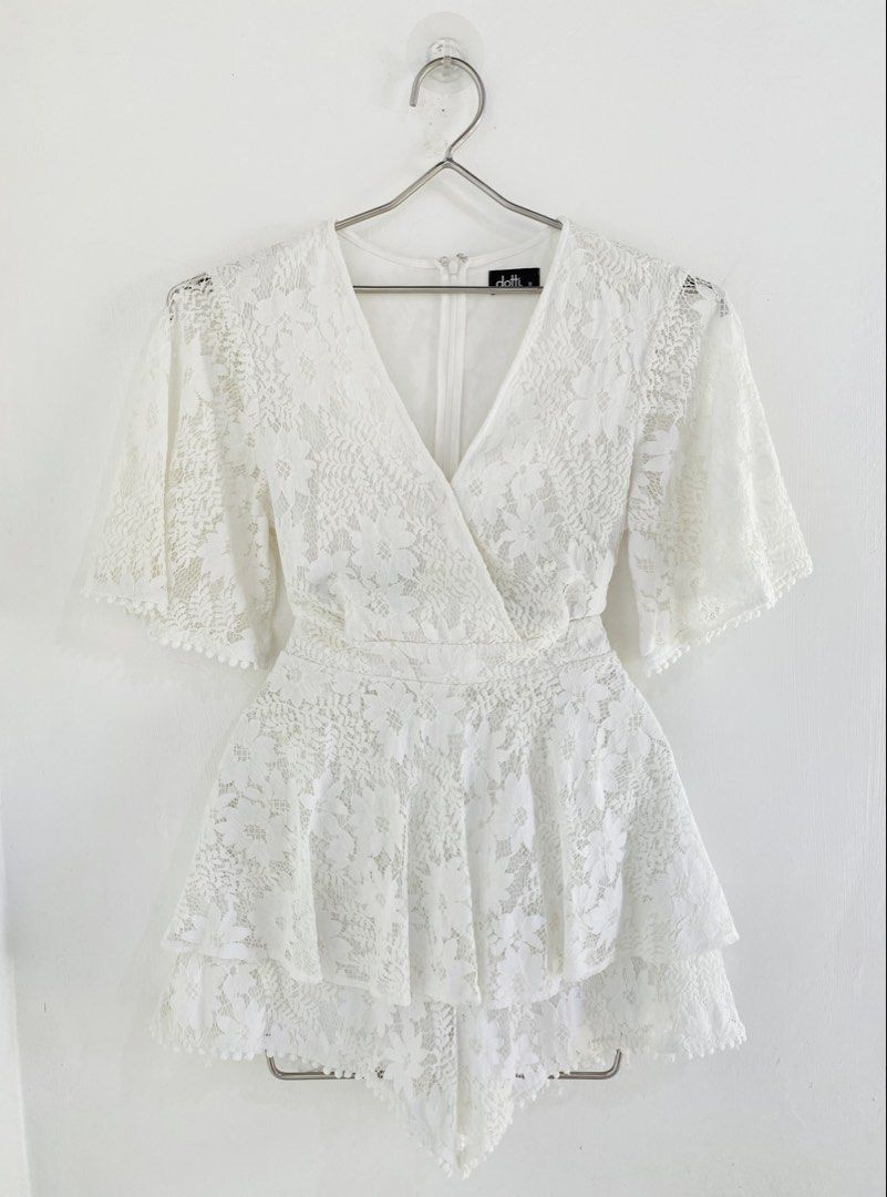 Dotti White Lace Wrap Romper (Category: Rompers) located in Vigan. Submitted by yourcloset1001 (Listing ID 1463912611, Image 1). Description: - Dotti white lace romper - Size 10 - Wrap front design - Flutter sleeves - Tiered ruffled hem - Tie detail at the back - Ideal for events or a night out.