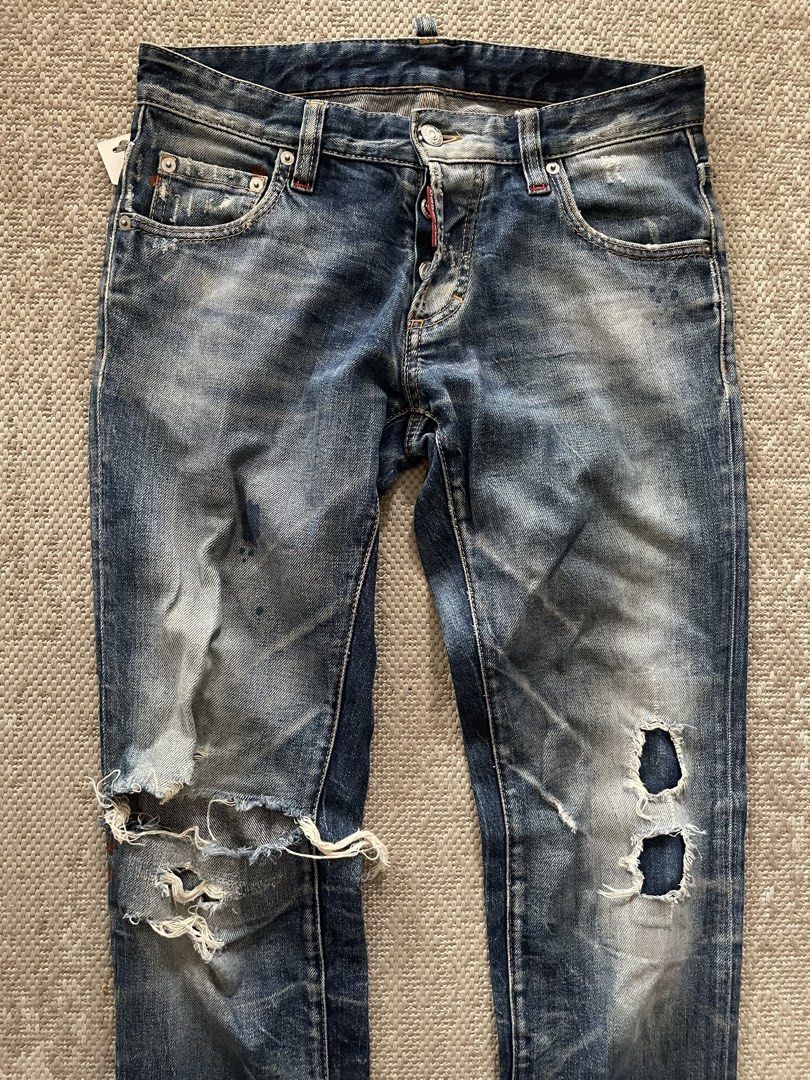 DSQUARED2 Distressed Blue Denim Jeans (Category: Jeans) located in Manila. Submitted by rei.ocn (Listing ID 1463850102, Image 2). Description: - Authentic DSQUARED2 jeans - Classic blue wash - Heavy distressing and rips on knees - Button fly closure - Signature DSQUARED2 logo detail on back pockets - Worn-in, casual, edgy style.