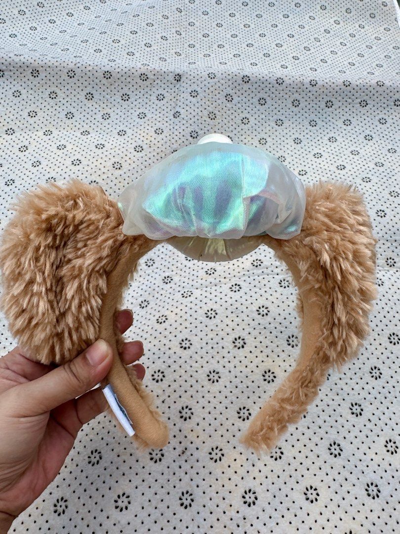 Duffy Bear Ears Headband with Iridescent Bow (Category: Hair Accessories) located in Manila. Submitted by ronoarabbit.ph (Listing ID 1463921864, Image 3). Description: - Adorable Duffy Bear ears design - Fluffy brown ear material - Features a shiny, iridescent bow in the center - Ideal for Disney fans and themed parties - Comfortable for all-day wear - Versatile accessory to complement any outfit.