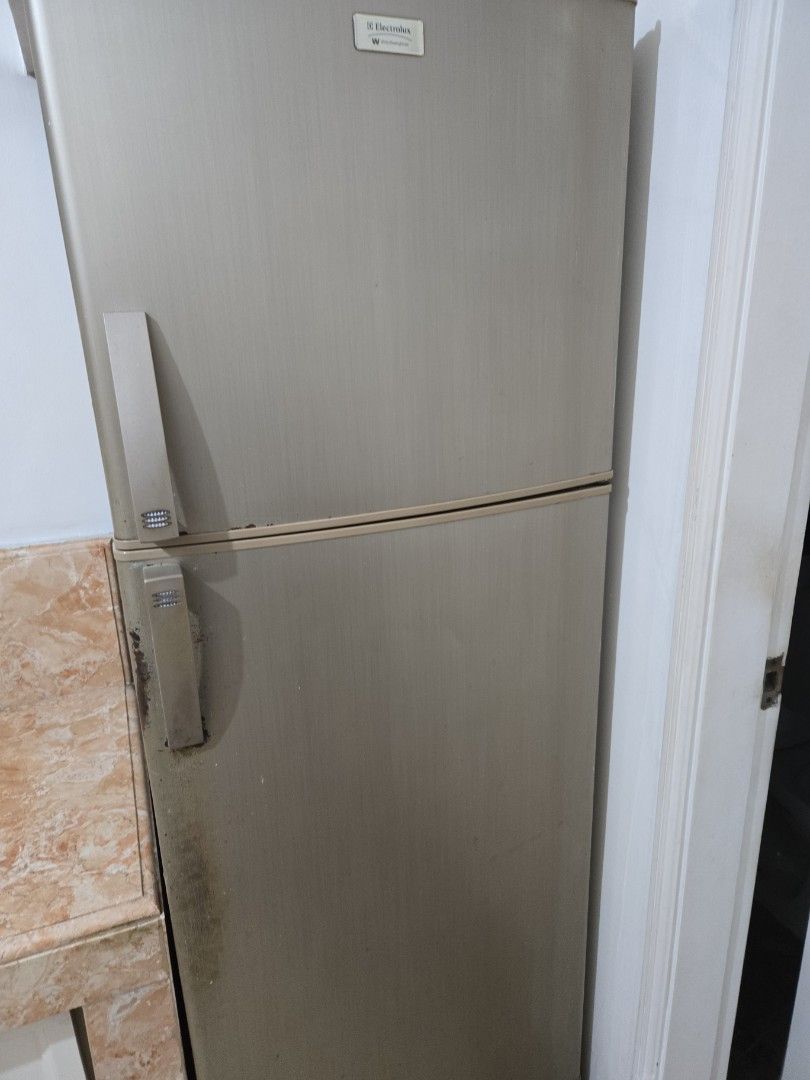 Electrolux Refrigerator (Category: Refrigerators and Freezers) located in Makati City. Submitted by cool1990 (Listing ID 1463770221, Image 1). Description: - Electrolux Refrigerator - Two Doors (Top Freezer) - Silver Finish - Visible marks/dirt on lower right door and handle area - Otherwise in decent condition.