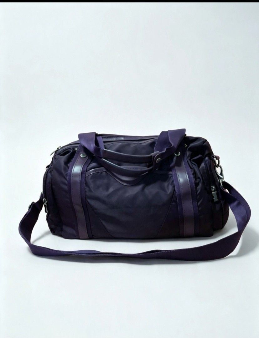 ELLE Purple Nylon Duffle Bag with Shoulder Strap (Category: Shoulder Bags) located in Angeles City. Submitted by anneps (Listing ID 1463831434, Image 1). Description: - Brand: ELLE - Color: Purple - Material: Nylon with leather accents - Features: Detachable shoulder strap, top handles, zipper closure - Interior detail: 'MADE IN KOREA' tag - Ideal for: Travel, gym.