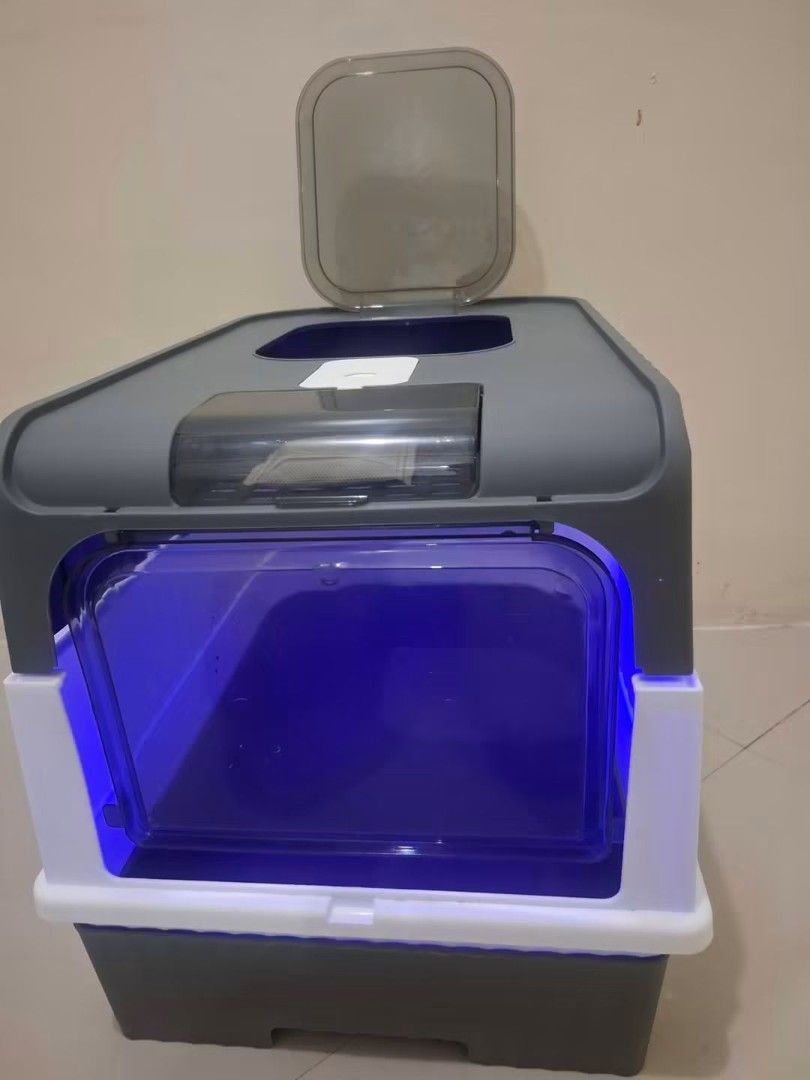 Enclosed Cat Litter Box with Odor Control (Category: Health & Grooming) located in Quezon City. Submitted by amai.closet (Listing ID 1463766421, Image 2). Description: - Stylish grey and white enclosed cat litter box - Large entry door for easy access - Top opening for convenient cleaning - Built-in filter for effective odor control - Unique blue interior light adds a modern touch - Spacious design suitable for most cats - Simple to scoop and mai