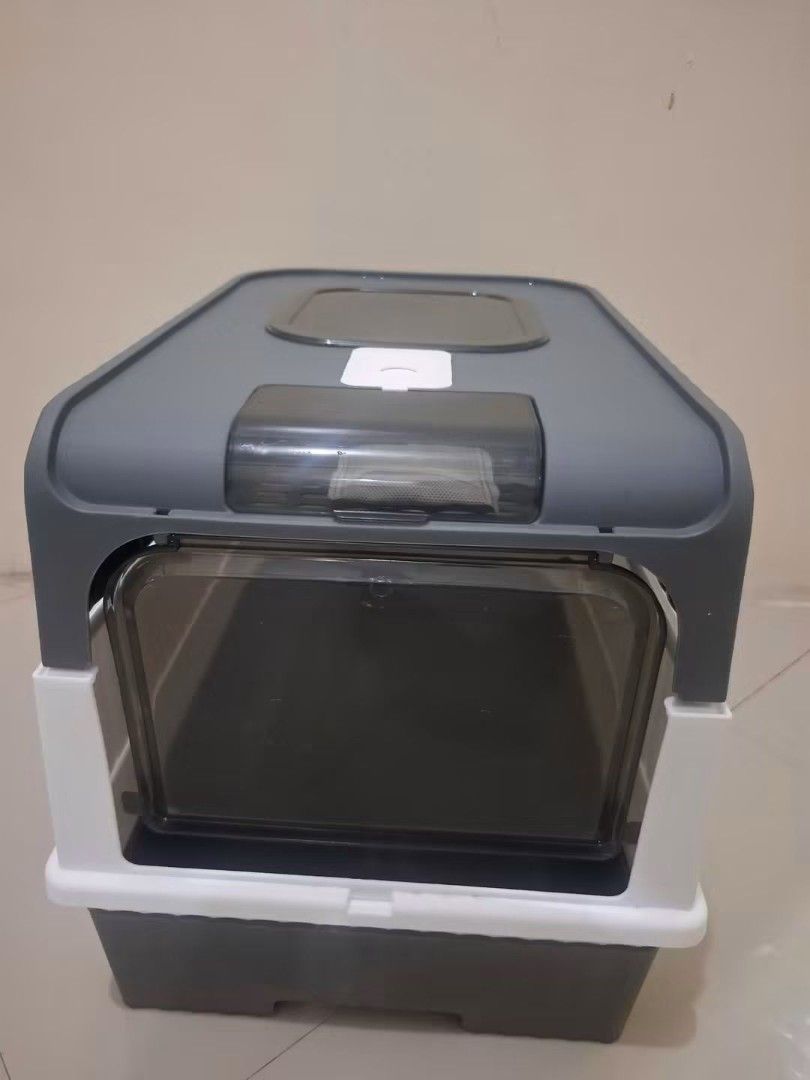 Enclosed Cat Litter Box with Odor Control (Category: Health & Grooming) located in Quezon City. Submitted by amai.closet (Listing ID 1463766421, Image 1). Description: - Stylish grey and white enclosed cat litter box - Large entry door for easy access - Top opening for convenient cleaning - Built-in filter for effective odor control - Unique blue interior light adds a modern touch - Spacious design suitable for most cats - Simple to scoop and mai