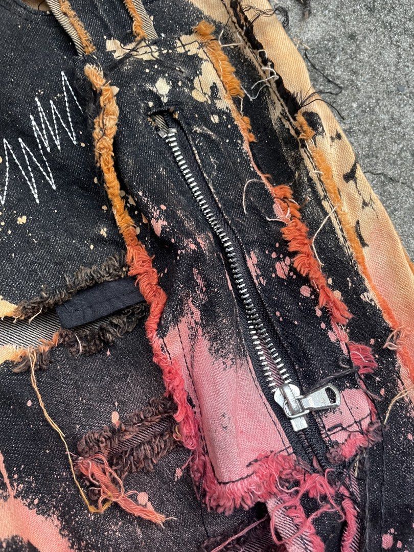 EV BRAVADO Distressed Bleached Denim Jeans (Category: Jeans) located in Pasay City. Submitted by qptingz (Listing ID 1463834987, Image 2). Description: - 2024 LVMH finalist EV BRAVADO - Unique distressed and bleached design - Black denim with pink and orange accents - Heavy distressing, rips, and frayed edges - Zipper fly with button closure - Ideal streetwear piece - Please check photos for detailed condition.