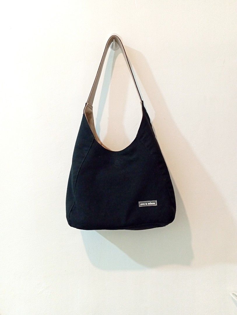 Eve & Adam Reversible Bag (Category: Shoulder Bags) located in Manila. Submitted by cococlo_ (Listing ID 1463832541, Image 1). Description: - Black canvas hobo bag from Eve & Adam - Relaxed, slouchy shape - Light tan interior lining - Front zippered pocket with gold-toned zipper pull - Simple and practical design.