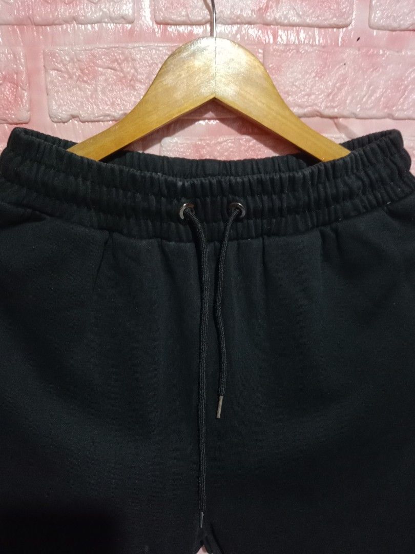 Evisu Big Dragon and Tiger Daicock (Category: Joggers) located in Davao. Submitted by ayeeasyshop13 (Listing ID 1463911693, Image 2). Description: a pair of black cotton jogger sweatpants featuring a large gold "Daicock" seagull print across the back, accented with detailed embroidered graphics of a fierce tiger and a mythical dragon or lion-dog surrounded by red flames. These style-forward streetwear pants draw inspiration from Evisu's signature