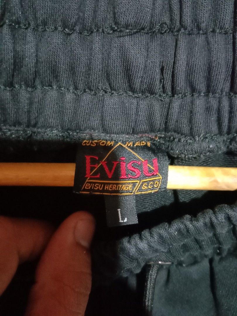 Evisu Big Dragon and Tiger Daicock (Category: Joggers) located in Davao. Submitted by ayeeasyshop13 (Listing ID 1463911693, Image 3). Description: a pair of black cotton jogger sweatpants featuring a large gold "Daicock" seagull print across the back, accented with detailed embroidered graphics of a fierce tiger and a mythical dragon or lion-dog surrounded by red flames. These style-forward streetwear pants draw inspiration from Evisu's signature