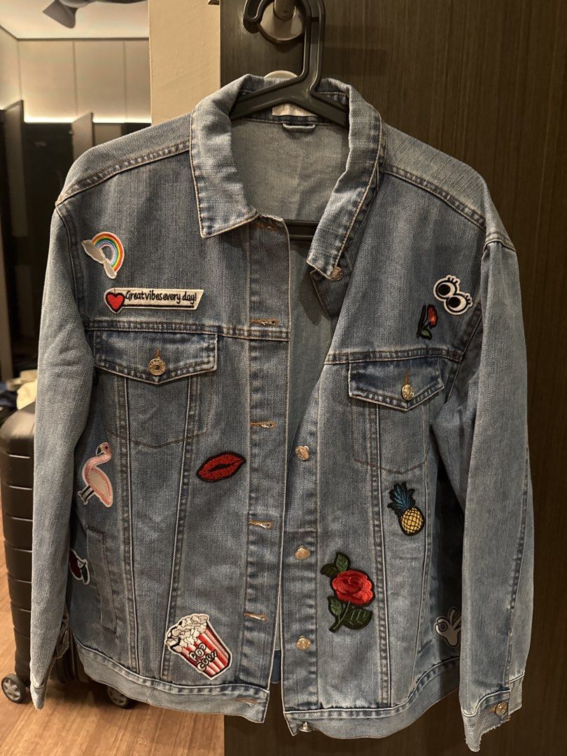 Fashmob Denim Patchwork Jacket (Category: Coats, Jackets and Outerwear) located in Singapore. Submitted by missyrt (Listing ID 1463899707, Image 1). Description: - FASHMOBdenim jacket - Features fun patches: rainbow, flamingo, lips, pineapple, and more - Classic button-up front - Versatile for layering or standalone wear - Adds personality to any outfit.