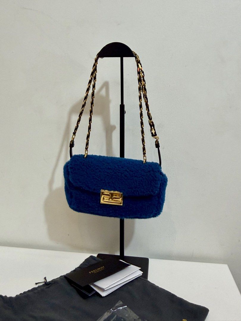 Fendi Blue Mini Baguette Shearling Bag w/ authenticity (Category: Luxury Bags & Wallets) located in Quezon City. Submitted by loveangelmusicbaby (Listing ID 1463915705, Image 3). Description: - Authentic Blue Fendi Bag with Authenticity card - 2 in 1 strap - Elegant Gold Chain Strap with Leather Accents - Iconic Fendi Logo Clasp - Includes Original Dust Bag - Made in Italy.