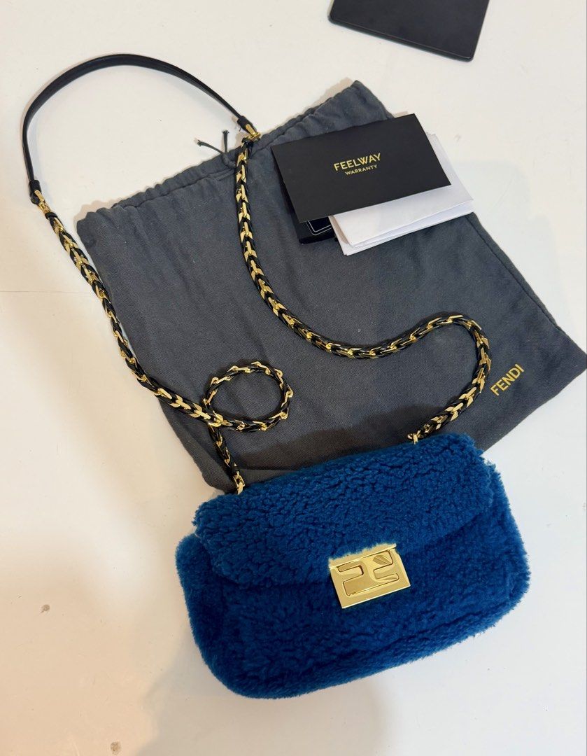 Fendi Blue Mini Baguette Shearling Bag w/ authenticity (Category: Luxury Bags & Wallets) located in Quezon City. Submitted by loveangelmusicbaby (Listing ID 1463915705, Image 2). Description: - Authentic Blue Fendi Bag with Authenticity card - 2 in 1 strap - Elegant Gold Chain Strap with Leather Accents - Iconic Fendi Logo Clasp - Includes Original Dust Bag - Made in Italy.