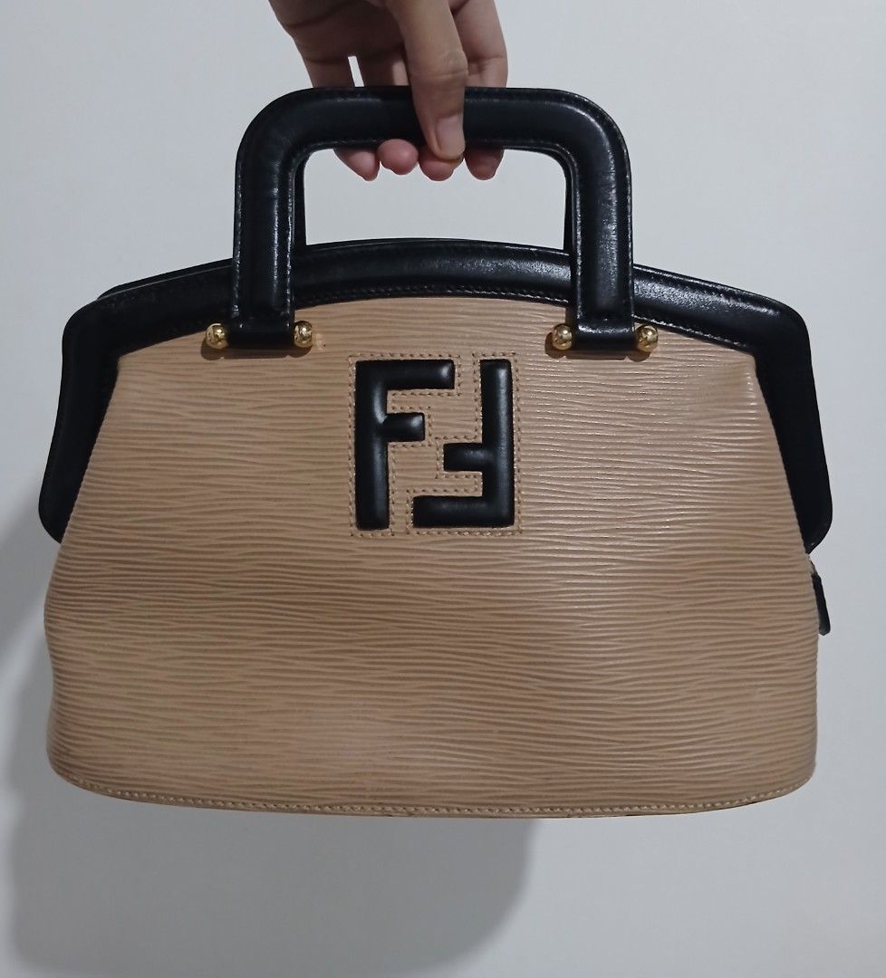 Fendi Zucca Monogram Canvas & Leather Handbag (Category: Luxury Bags & Wallets) located in Alaminos. Submitted by sachiKaSan (Listing ID 1463866277, Image 1). Description: - Authentic Fendi handbag - Iconic black Zucca logo on beige canvas - Black leather top handles and trim - Gold hardware details - Interior Fendi Made in Italy plaque - Timeless and classic design.