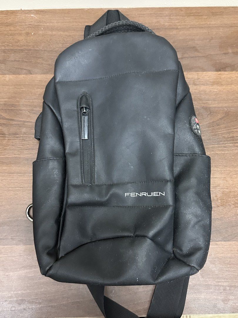 FENRUIN Black Sling Bag (Category: Sling Bags) located in Manila. Submitted by itsaladean (Listing ID 1463867298, Image 1). Description: - Black FENRUIN sling bag - Front zippered pocket - wit USB port - Side pockets for water bottles/small items - Padded back for comfort - Adjustable strap - Ideal for everyday use.