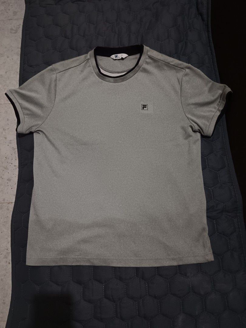 Fila Grey T-shirt (Category: Tshirts & Polo Shirts ) located in Davao. Submitted by jjj_mncd (Listing ID 1463875094, Image 1). Description: width: 21 length: 26 - Grey Fila T-shirt - Small Fila logo on front - Ribbed collar and sleeve cuffs - Suitable for sports or casual wear.