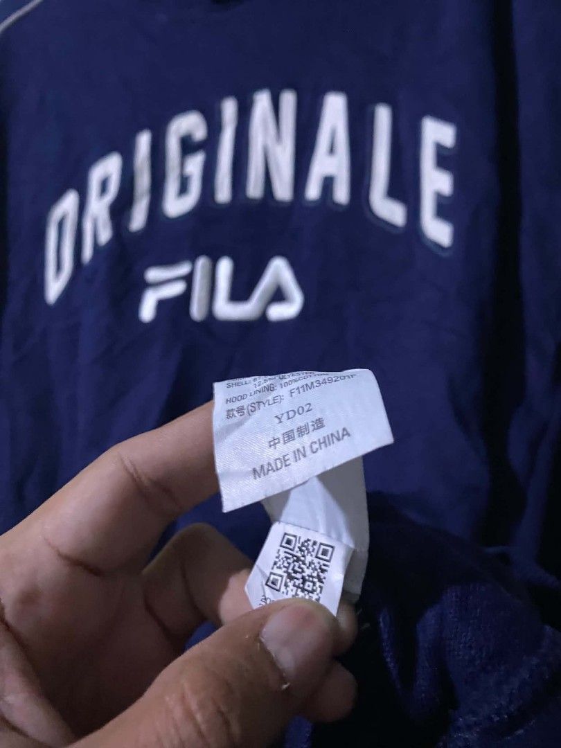 Fila "Originale" Navy Blue Hoodie (Category: Coats, Jackets and Outerwear) located in Caloocan City. Submitted by vincefresn21903 (Listing ID 1463759103, Image 3). Description: - Navy blue Fila hoodie - 'Originale' graphic detail - White piping along sleeves - Front kangaroo pocket - Size S (165/88A) - Made in China - Ideal for casual wear.