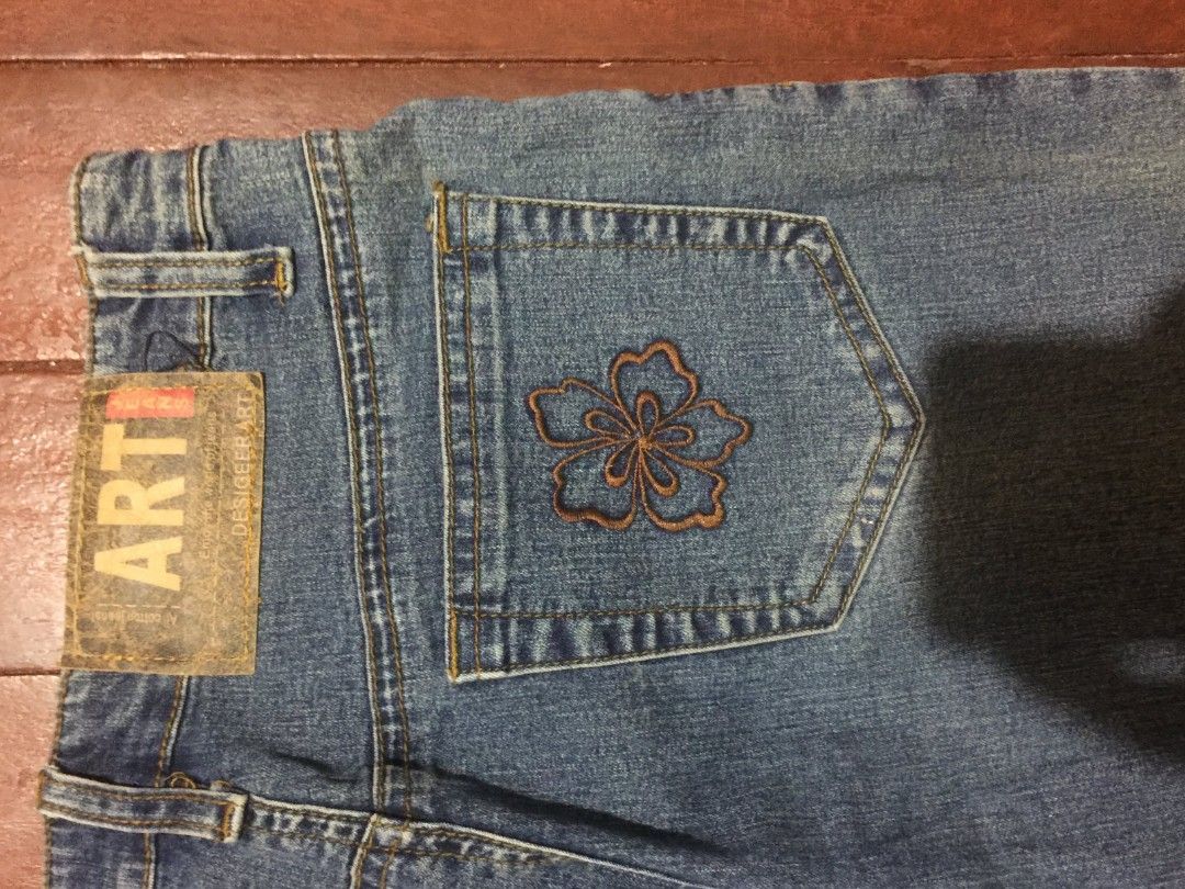 FLARED PANTS WITH EMBROIDERED FLOWER DESIGN (Category: Jeans) located in Manila. Submitted by carlosrexc26753 (Listing ID 1463915234, Image 3). Description: - Style: flared blue denim jeans - Unique Details: Floral embroidery and bead embellishments on front and back pockets - Look: Distinctive and stylish, perfect for adding flair.