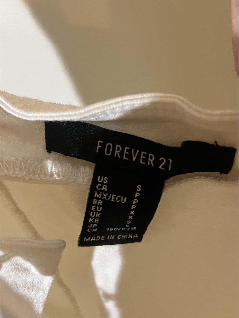 Forever 21 White Hook and Eye Mini Dress (Category: Dresses) located in Cainta. Submitted by caffinjty (Listing ID 1463825814, Image 2). Description: - Adjustable straps - Hook and eye closure down the front - Denim-like or thick cotton material.