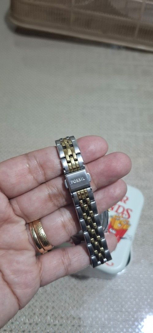 Fossil Two-Tone Watch with Green Dial (Category: Women's Watches) located in Bulacan. Submitted by mymeelhet (Listing ID 1463789334, Image 2). Description: - Two-tone stainless steel and gold-colored band - Classic green dial with Roman numerals - Convenient date window - Original Fossil tin included - Fossil logo on clasp - Versatile for everyday or dressy wear.