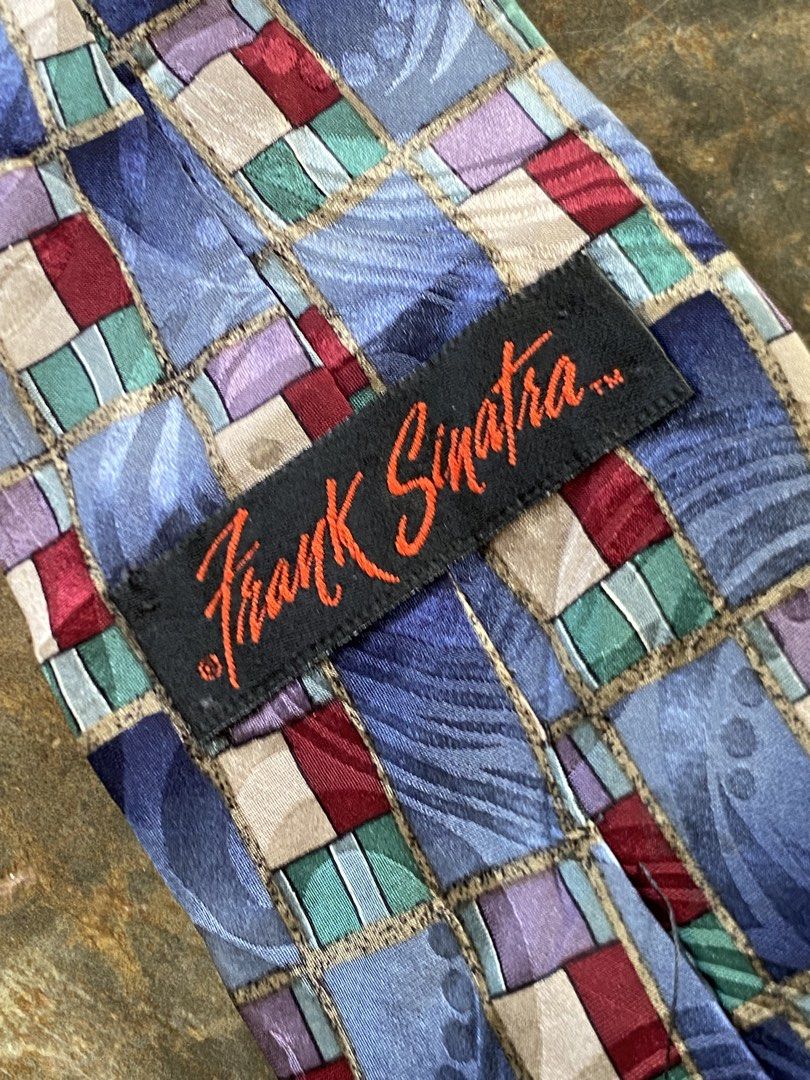 Frank Sinatra Midtown Birthday Collection Tie (Category: Ties) located in Dapitan. Submitted by bolandojh07634 (Listing ID 1463911362, Image 3). Description: - Unique patterned tie featuring a Frank Sinatra label. - Part of the exclusive Midtown Birthday Collection. - Eye-catching pattern with blue, purple, red, and green squares. - Ideal for collectors or adding flair to a special occasion..