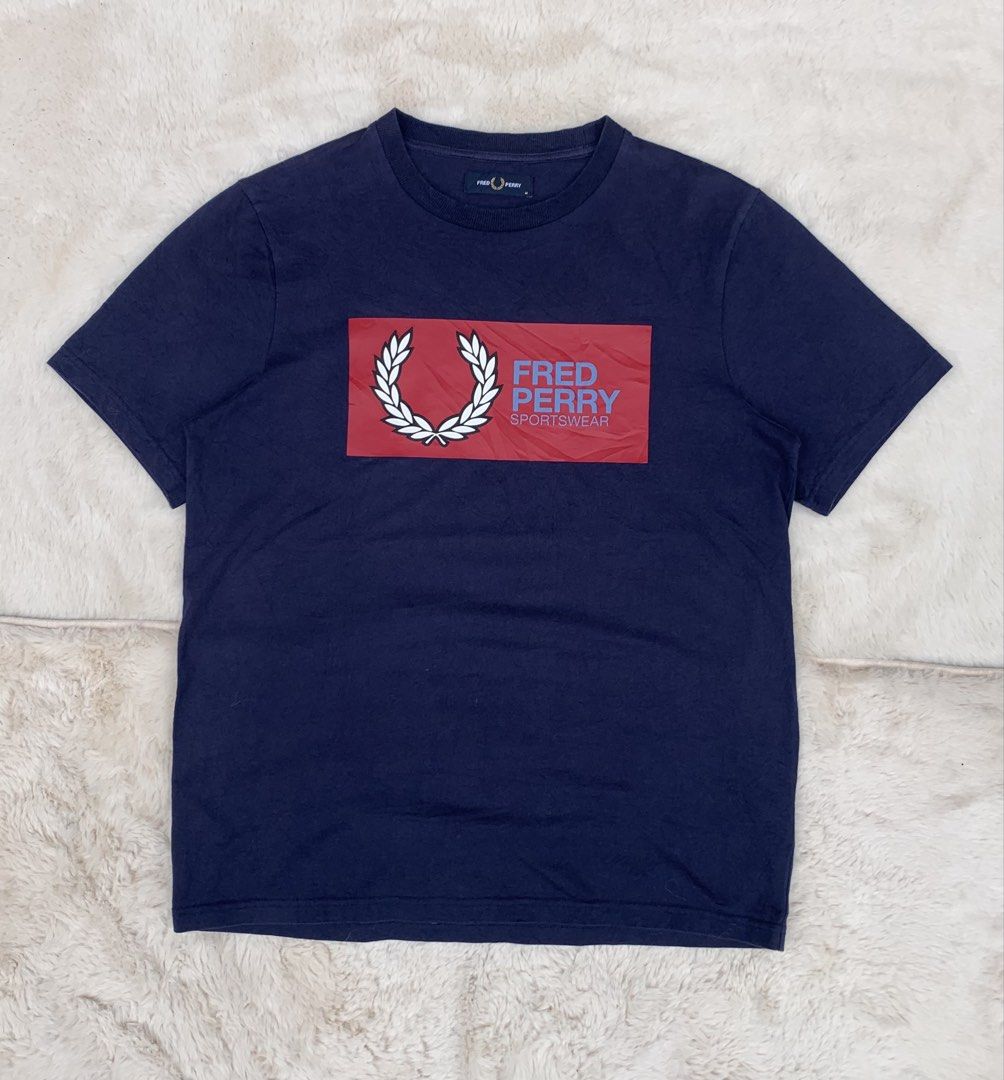 Fred Perry Navy Blue T-Shirt Size M (Category: Tshirts & Polo Shirts ) located in Cateel. Submitted by janicegpad45049 (Listing ID 1463881111, Image 2). Description: - Navy blue Fred Perry T-shirt - Size: Medium (M) - Iconic laurel wreath logo on a red block detail - Made in China - Ideal for everyday casual wear.