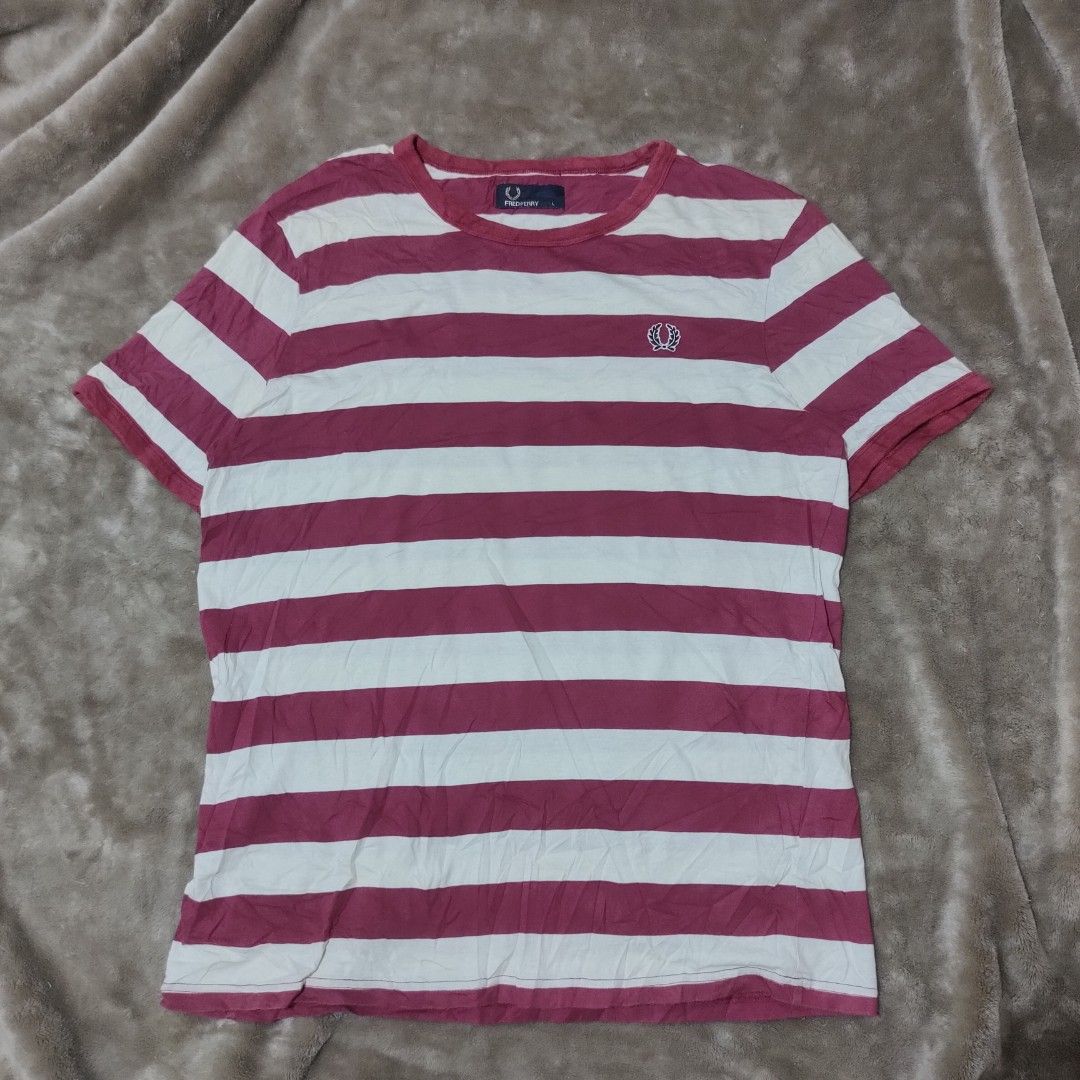 Fred Perry Striped T-Shirt Size L (Category: Tshirts & Polo Shirts ) located in Taguig. Submitted by actualizeboutique (Listing ID 1463864091, Image 1). Description: - Classic Fred Perry T-shirt - Features stylish horizontal stripes in pink and white - Comfortable 100% cotton fabric - Classic crew neck and short sleeves - Iconic embroidered Fred Perry laurel wreath logo on the chest - Ideal for everyday casual wear.