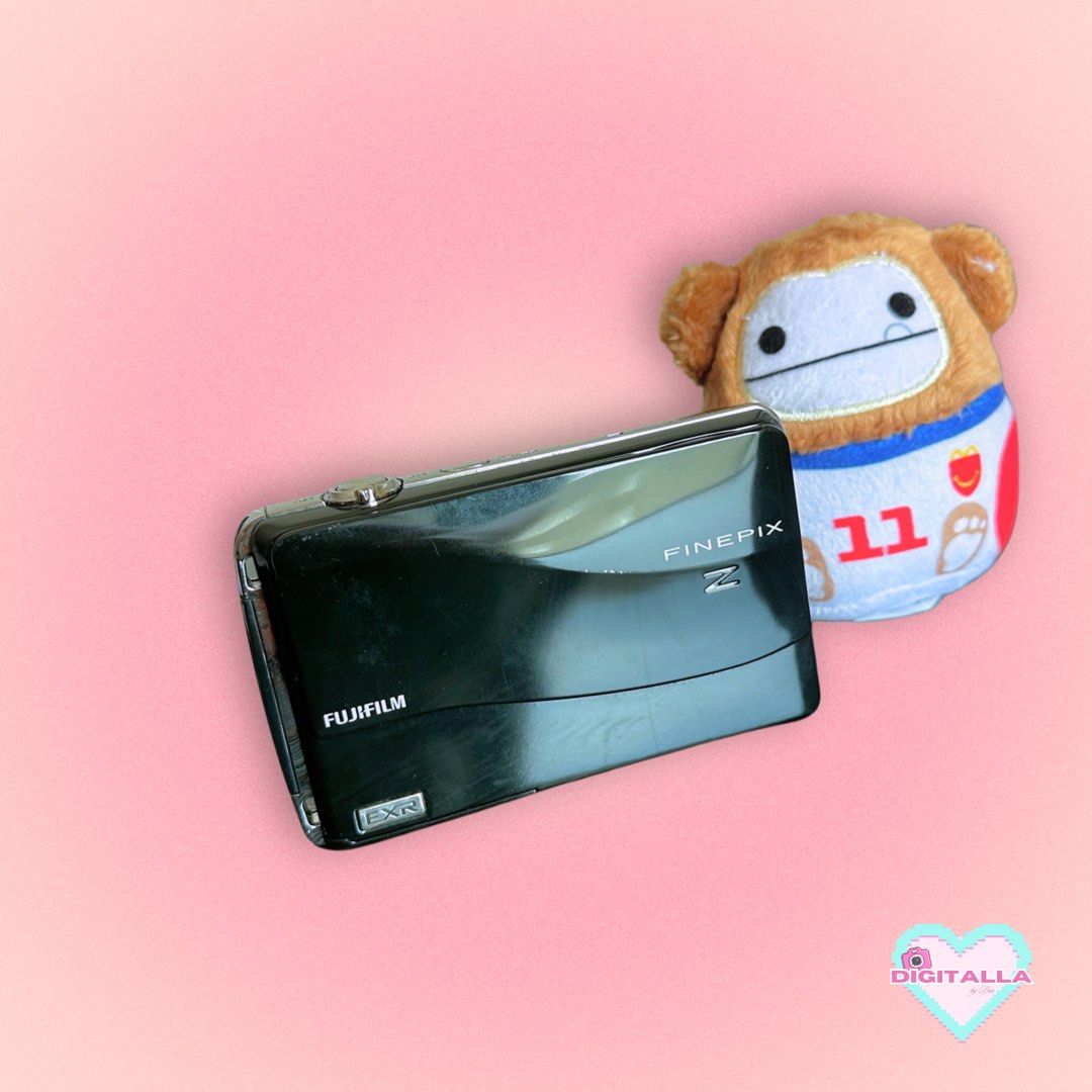 Fujifilm Z700 EXR Digicam Digital Camera (Category: Cameras) located in Iloilo. Submitted by alyssadia (Listing ID 1459660451, Image 1). Description: 𝐅𝐮𝐣𝐢𝐟𝐢𝐥𝐦 𝐅𝐢𝐧𝐞𝐏𝐢𝐱 𝐙𝟕𝟎𝟎 𝐄𝐗𝐑 (𝐁𝐥𝐚𝐜𝐤) ✧･ﾟ🖤📸 ┆ ⤿ 🌸 . ݁˖ 𝐃𝐄𝐓𝐀𝐈𝐋𝐒 ✧ 12MP EXR CMOS Sensor ✧ 5x Optical Zoom Fujinon Lens ✧ 720p HD Video Recording ✧ 3.0” Touchscreen LCD ✧ EXR Auto Mode for Low-Light/HDR Shots ✧ Body Condition: 8.5/10 — slight paint chips ✧ LCD: 9/10, wi