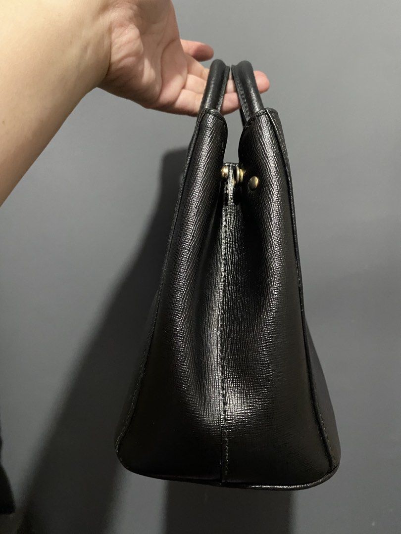 Furla Black Leather Tote Bag (Category: Luxury Bags & Wallets) located in Batangas. Submitted by bagstolove3.0 (Listing ID 1463901053, Image 2). Description: - Classic black Furla leather bag. - Textured leather finish for a sophisticated look. - Elegant gold hardware, including the iconic Furla logo charm. - Comfortable top handles for easy carrying. - Structured design with protective metal feet on the bottom. - An ideal and stylish everyday ba