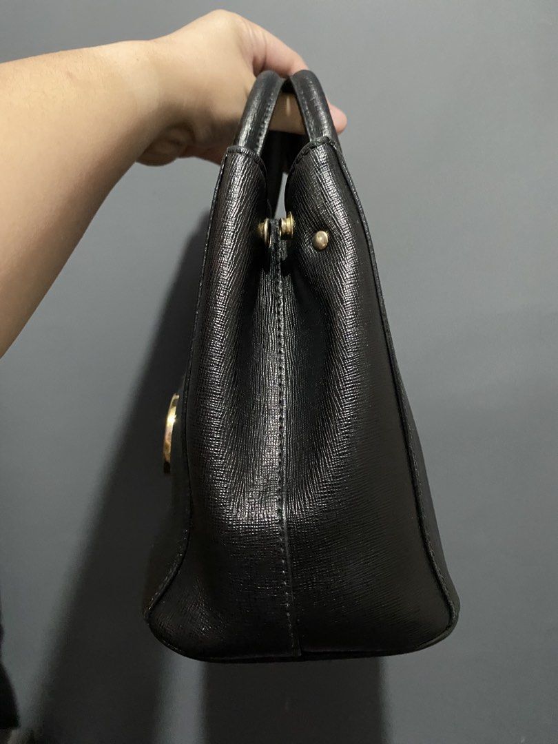 Furla Black Leather Tote Bag (Category: Luxury Bags & Wallets) located in Batangas. Submitted by bagstolove3.0 (Listing ID 1463901053, Image 3). Description: - Classic black Furla leather bag. - Textured leather finish for a sophisticated look. - Elegant gold hardware, including the iconic Furla logo charm. - Comfortable top handles for easy carrying. - Structured design with protective metal feet on the bottom. - An ideal and stylish everyday ba