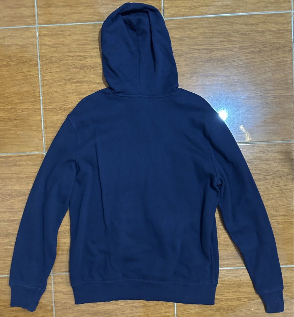 GAP Navy Blue Hoodie Sweatshirt (Category: Coats, Jackets and Outerwear) located in Valenzuela. Submitted by everydaysale_deni (Listing ID 1463881203, Image 2). Description: - Iconic white and red GAP logo across the chest - Features a front kangaroo pocket - Ideal for everyday casual wear.