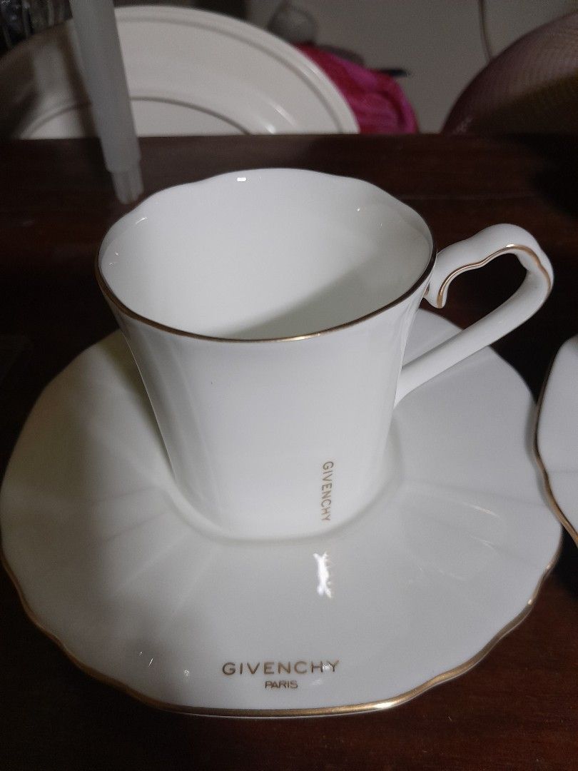 Givenchy Paris Bone China Cup and Saucer Set (Category: Coffee & Tea Tableware) located in San Pedro. Submitted by resa70 (Listing ID 1463755671, Image 3). Description: - Authentic Givenchy Paris white bone china cup and saucer set. - Exquisitely crafted in Japan by Yamaka International. - Features a delicate gold trim on the cup rim and handle. - The saucer proudly displays the Givenchy Paris logo. - A timeless and sophisticated addition to any 