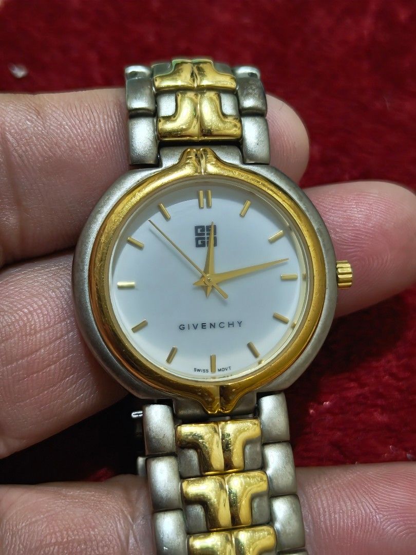 Givenchy vintage watch (Category: Luxury Watches) located in Makati City. Submitted by ljdelima.102 (Listing ID 1463854421, Image 1). Description: Vintage Givenchy Two-Tone Swiss Quartz Luxury Dress Watch – White Dial Product Details Brand: Givenchy Movement: Swiss Quartz (Battery Operated) Working Dial Color: White with gold accents Case & Band Material: Stainless steel with gold-plated accents Band Style: Two-tone link bracelet with textured ce
