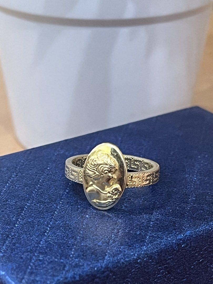 Gold Ring with Oval Cameo Portrait (Category: Rings) located in Manila. Submitted by missyoung222 (Listing ID 1463799046, Image 1). Description: - Elegant gold ring - Features an oval cameo portrait on the face - Band has a textured pattern - Classic, vintage-inspired design - Perfect for adding a timeless touch to any outfit.