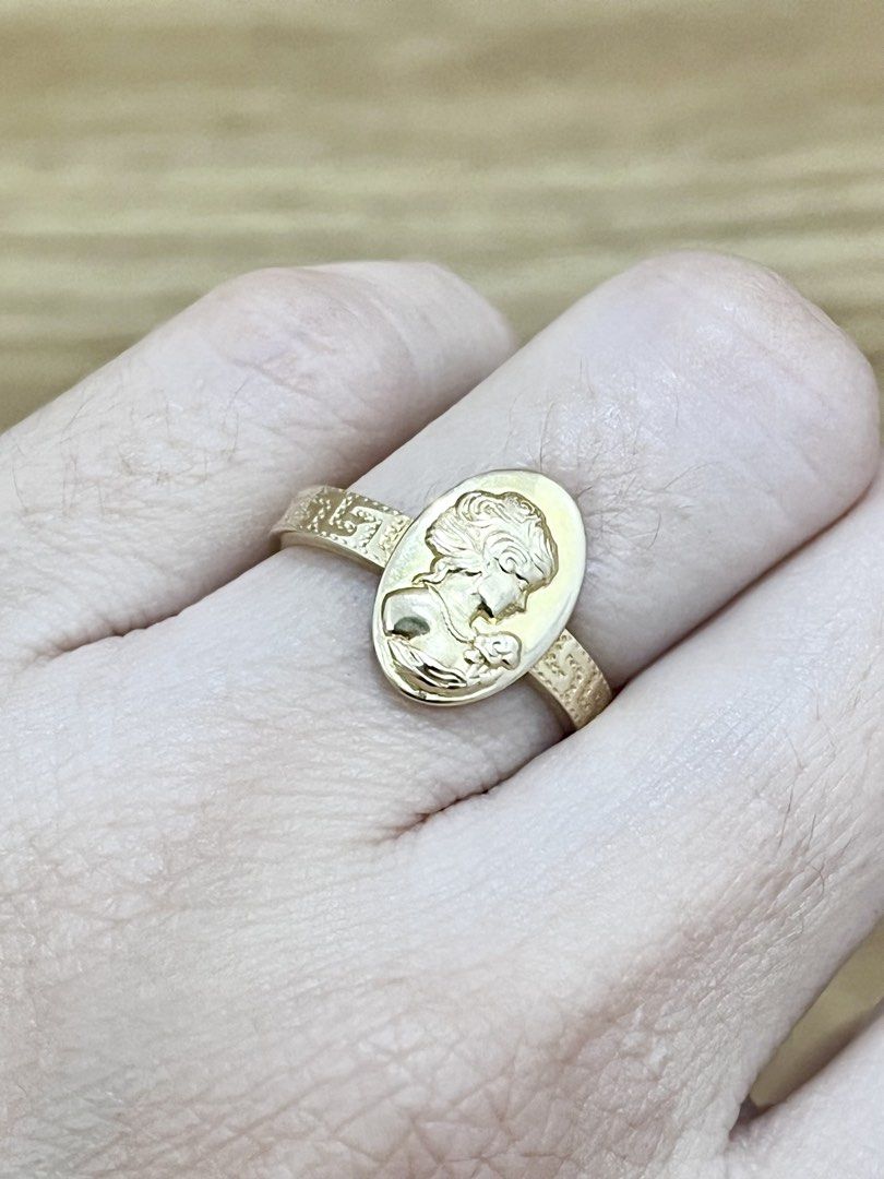 Gold Ring with Oval Cameo Portrait (Category: Rings) located in Manila. Submitted by missyoung222 (Listing ID 1463799046, Image 2). Description: - Elegant gold ring - Features an oval cameo portrait on the face - Band has a textured pattern - Classic, vintage-inspired design - Perfect for adding a timeless touch to any outfit.