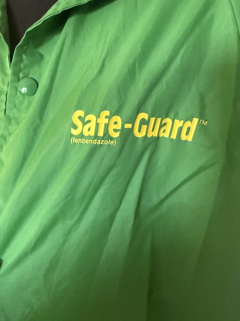Green Nylon Jacket (Category: Coats, Jackets and Outerwear) located in Manila. Submitted by cristycrab247 (Listing ID 1463772138, Image 3). Description: - Green coach jacket - Features 'Safe-Guard' and '(fenbendazole)' logo on chest - Button-up front with convenient pockets - Adjustable drawstring hem for a customized fit - Made from lightweight material, ideal for layering - originally bought for a DIY project. Label should be easy to remove or 