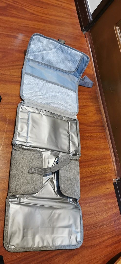 Grey Diaper Changing Clutch with Pockets and Changing Pad (Category: Luxury Bags & Wallets) located in Moncada. Submitted by gwatstuffshopaholic (Listing ID 1463862001, Image 2). Description: - Stylish grey diaper clutch for on-the-go convenience. - Folds out to reveal a built-in changing pad. - Multiple pockets for organizing diapers and essentials. - Top mesh pocket for easy access to small items. - Clear window specifically designed for wipes.