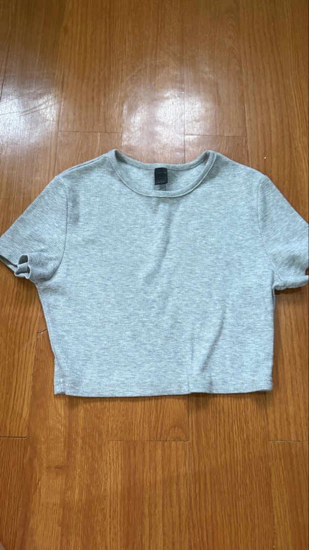 Grey Ribbed Cropped T-shirt (Category: Shirts) located in Antipolo. Submitted by japanese.siomai (Listing ID 1463797025, Image 1). Description: - Grey ribbed cropped t-shirt - Short sleeves - Cute cutout detail on the left sleeve - Simple and versatile - Great for casual wear or layering.