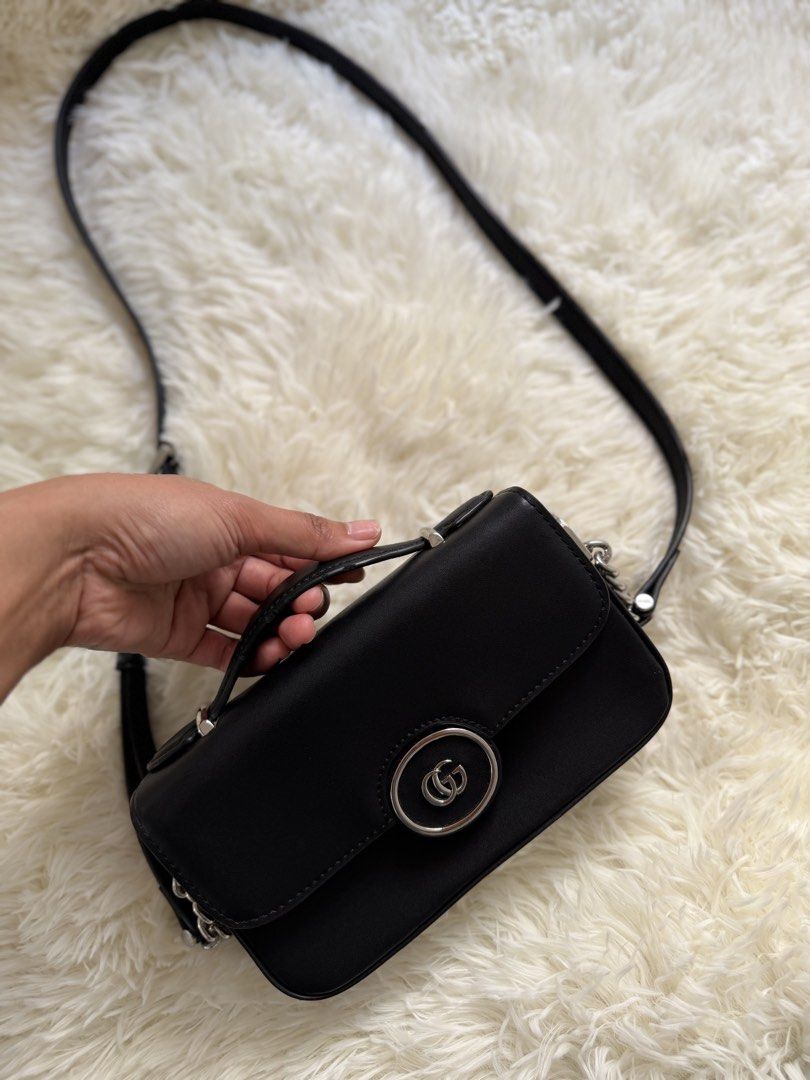 Gucci Black Leather Shoulder Bag (Category: Luxury Bags & Wallets) located in Cebu City. Submitted by gdcebu (Listing ID 1463923652, Image 2). Description: Black leather shoulder bag from Gucci. Features a chain strap and top handle. Interior has a zippered pocket. Made in Italy. Clean inside and out. Great for everyday use or nights out..