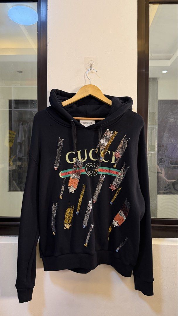 Gucci Black Sequin Logo Hoodie (Category: Coats, Jackets and Outerwear) located in Paranaque City. Submitted by mykapoynton (Listing ID 1463831086, Image 2). Description: Gucci Black Sequin Logo Hoodie - Features eye-catching sequin logo detail - Made in Italy for premium quality - Comfortable and stylish design - Ideal for everyday casual wear.