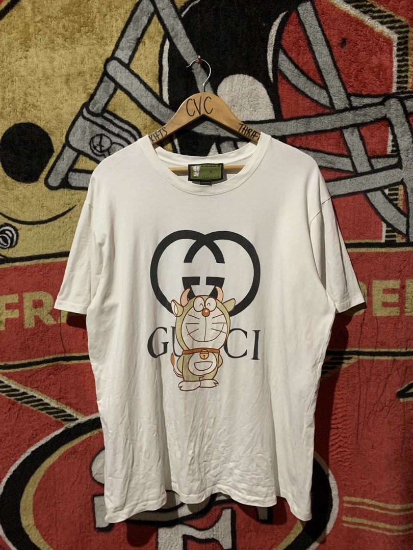 GUCCI DOREAMON TEE (Category: Tshirts & Polo Shirts ) located in Tayug. Submitted by cvcthrift (Listing ID 1463787019, Image 1). Description: 24/30 ISSUE STAIN see last photo EXCELLENT CR-9.5/10 .