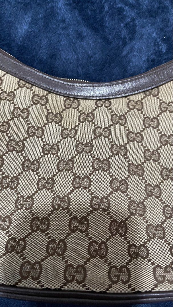 Gucci Monogram Canvas Shoulder Bag (Category: Luxury Bags & Wallets) located in Quezon City. Submitted by leila_collection (Listing ID 1463856183, Image 1). Description: - Authentic Gucci shoulder bag - Classic GG monogram canvas with brown leather trim - Interior zip pocket for essentials - Signature green and red stripe strap - Serial number visible inside - Ideal everyday bag - needs cleaning / bag spa - replaced zipper.