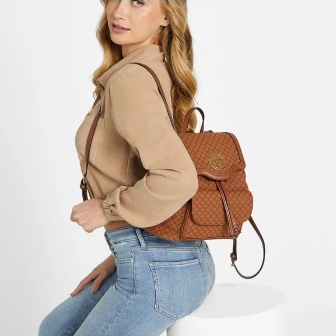 Guess Brown Woven Flap Backpack (Category: Backpacks) located in Santa Rosa. Submitted by BerrieBlossom (Listing ID 1463881673, Image 2). Description: - Brown Guess backpack with a chic woven pattern. - Secure drawstring closure with a flap top. - Convenient front pockets with button closure. - Adjustable straps for a comfortable fit. - Ideal for everyday use, blending style and practicality..