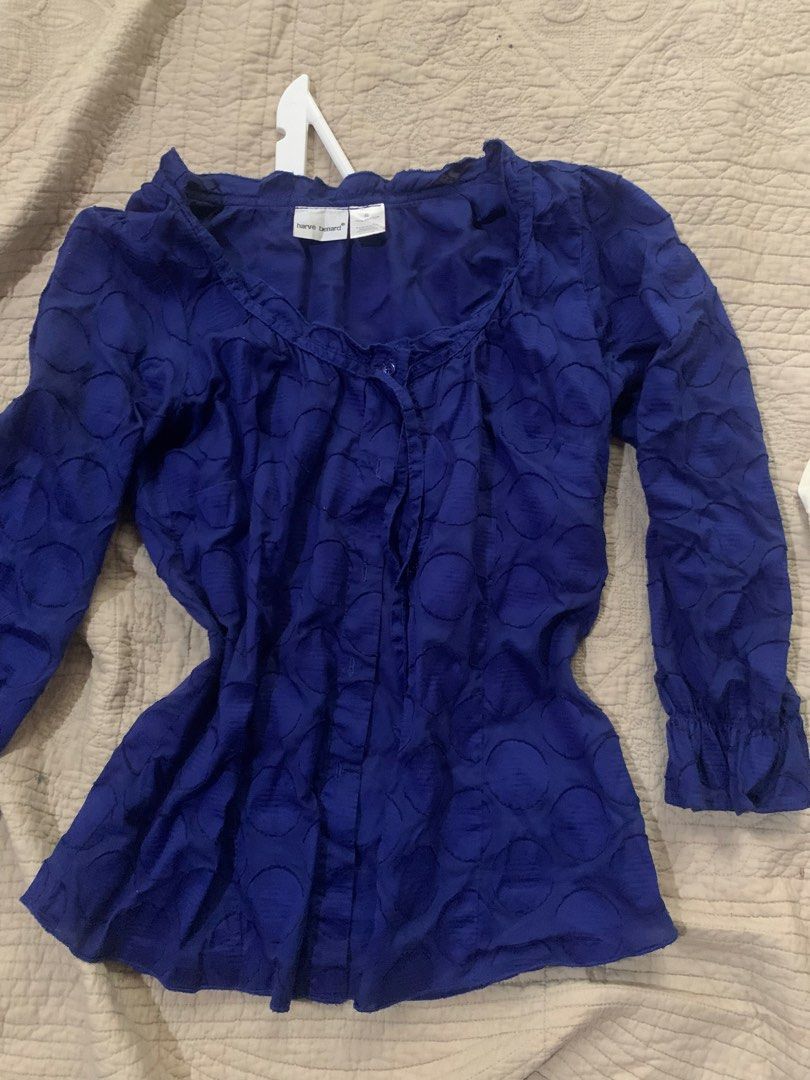 Harve Benard Blue Textured Button-Up Blouse (Category: Blouses) located in Manila. Submitted by spaceshop12345 (Listing ID 1463806971, Image 3). Description: - Blue long-sleeve blouse from Harve Benard - Features a unique textured circle pattern all over - Button-up front for adjustable styling - Elegant ruffled neckline adds a feminine touch - Ruffled cuffs on the sleeves for added detail - Perfect for pairing with jeans or skirts - Suitable for