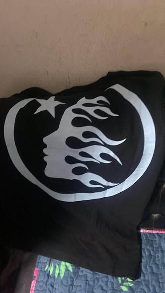Hellstar Tshirt "Shout Out To The Underground" (Category: Tshirts & Polo Shirts ) located in Caloocan City. Submitted by warymclovin (Listing ID 1463874960, Image 2). Description: - Selling to make a living - Black t-shirt with a striking skeleton and flame graphic. - Features text: 'Play on Rock n Roll' and 'Shout out to the Underground'. - Brand new with tag attached. - Estimated size: Medium or Large. - Ideal for casual wear and expressing you