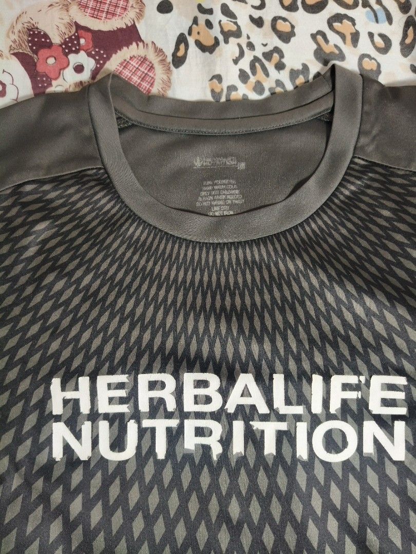 Herbalife Nutrition T-shirt (Category: Tshirts & Polo Shirts ) located in Lapu Lapu. Submitted by hooman422 (Listing ID 1463808314, Image 2). Description: - Dark Grey t-shirt with Herbalife Nutrition logo - Short sleeves, crew neck - Geometric pattern on the front - Plain grey back - Perfect for workouts or casual wear.