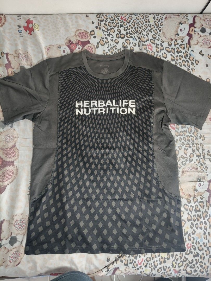 Herbalife Nutrition T-shirt (Category: Tshirts & Polo Shirts ) located in Lapu Lapu. Submitted by hooman422 (Listing ID 1463808314, Image 1). Description: - Dark Grey t-shirt with Herbalife Nutrition logo - Short sleeves, crew neck - Geometric pattern on the front - Plain grey back - Perfect for workouts or casual wear.