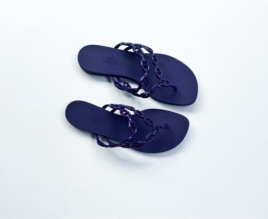 Hermes Island Sandals (Category: Flats & Sandals) located in Davao. Submitted by LUXURY (Listing ID 1463827227, Image 1). Description: Hermes Island sandals in violet iris colorway with chain detail. Rubber sole. Slip-on. Casual wear/beach. Size 38 Pair only Visit my profile for more luxury items.