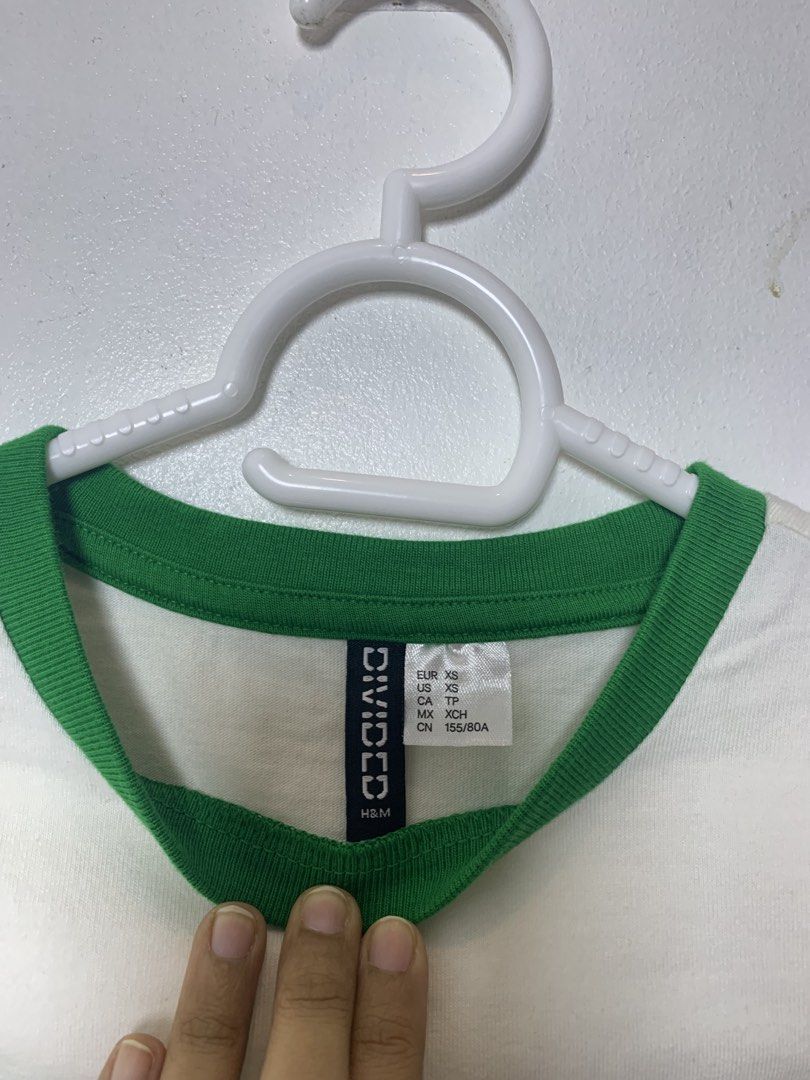 H&M Divided White 'Mi Amore' Ringer Tee (Category: Shirts) located in San Pedro. Submitted by reginacarla (Listing ID 1463767573, Image 3). Description: - H&M Divided white ringer tee - Features 'Mi Amore' graphic in green - Green trim on collar and sleeves - Cropped style - Ideal for casual wear RFS: Decluttering ✨ ₱200 negotiable 😊 📦 SF/delivery fee c/o buyer 🚚 Lalamove / Grab / J&T available 💳 GCash.