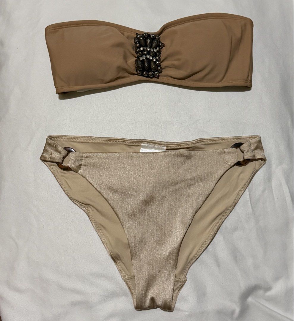 H&M Tan Beaded Bandeau Bikini Set (Category: Bikinis & Swimsuits) located in Paranaque City. Submitted by declutternsell.729 (Listing ID 1463776468, Image 1). Description: - H&M Tan Bikini Set - Bandeau top with beaded embellishment at the front - Bottoms with ring details on the sides - Size: small - Ideal for beach days or pool parties SOLD AS SET.