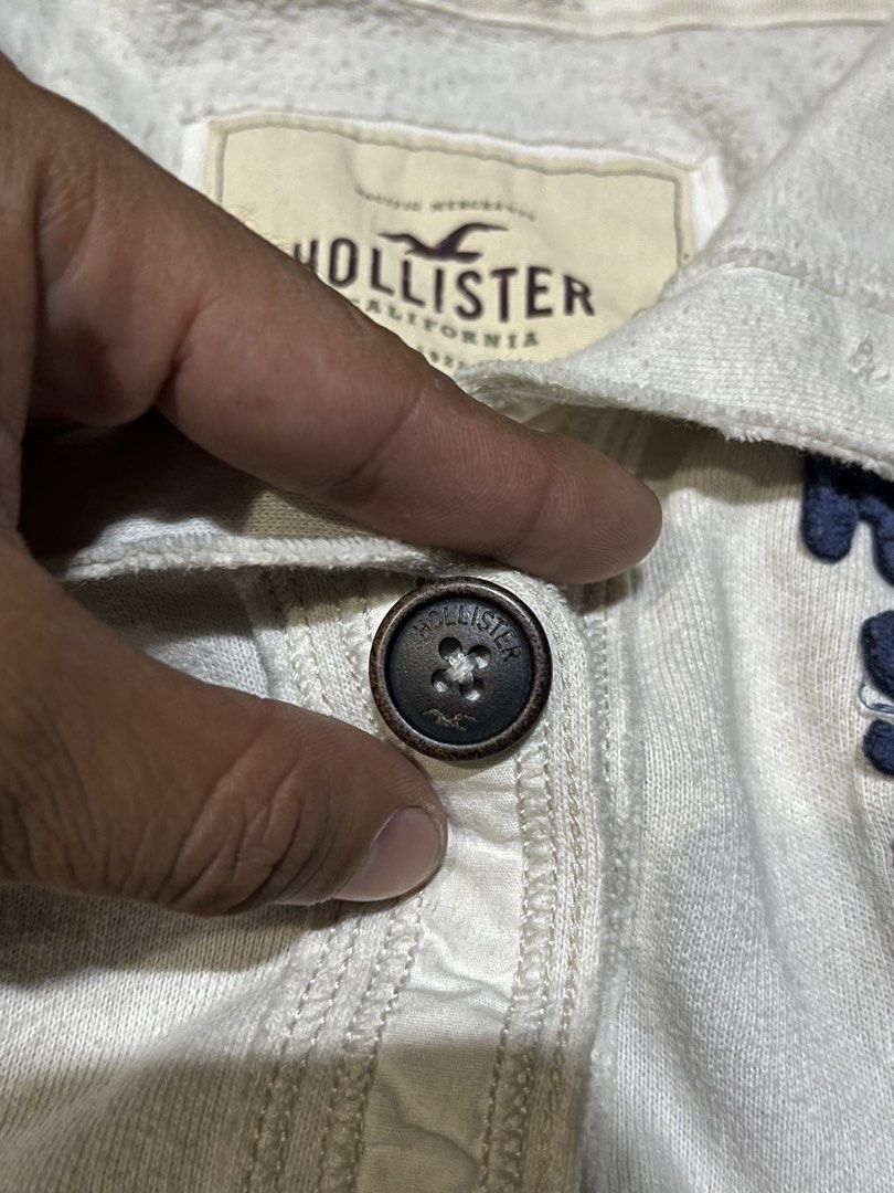 Hollister Surf Team White Button Up Jacket Size M (Category: Coats, Jackets and Outerwear) located in San Isidro, Leyte. Submitted by tigerxdx3580077 (Listing ID 1463880886, Image 3). Description: - White Hollister jacket - 'Hollister Surf Team' graphic - Button-up front - Collared neckline - Long sleeves with ribbed cuffs - Size: Medium (M) - Ideal for casual wear.
